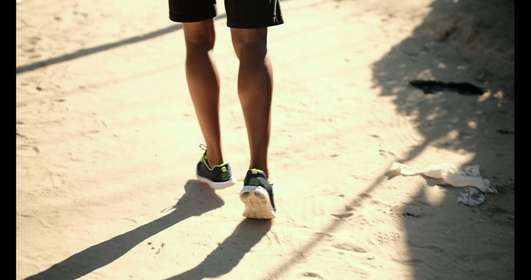 Jogging on Sandy Beach Trail in Afternoon Sunshine