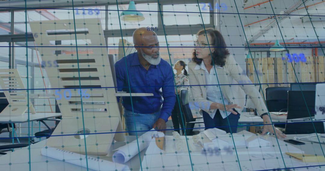 Diverse Professionals Analyzing Business Data with Technology in Office