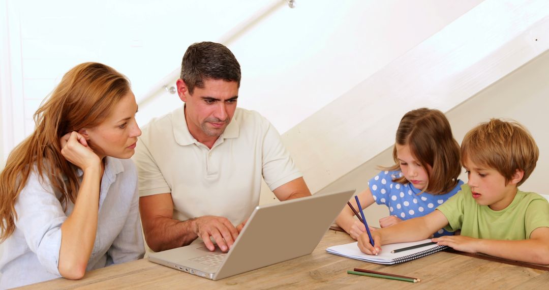 Parents Helping Children with Homework Using Laptop at Home - Free Images, Stock Photos and Pictures on Pikwizard.com