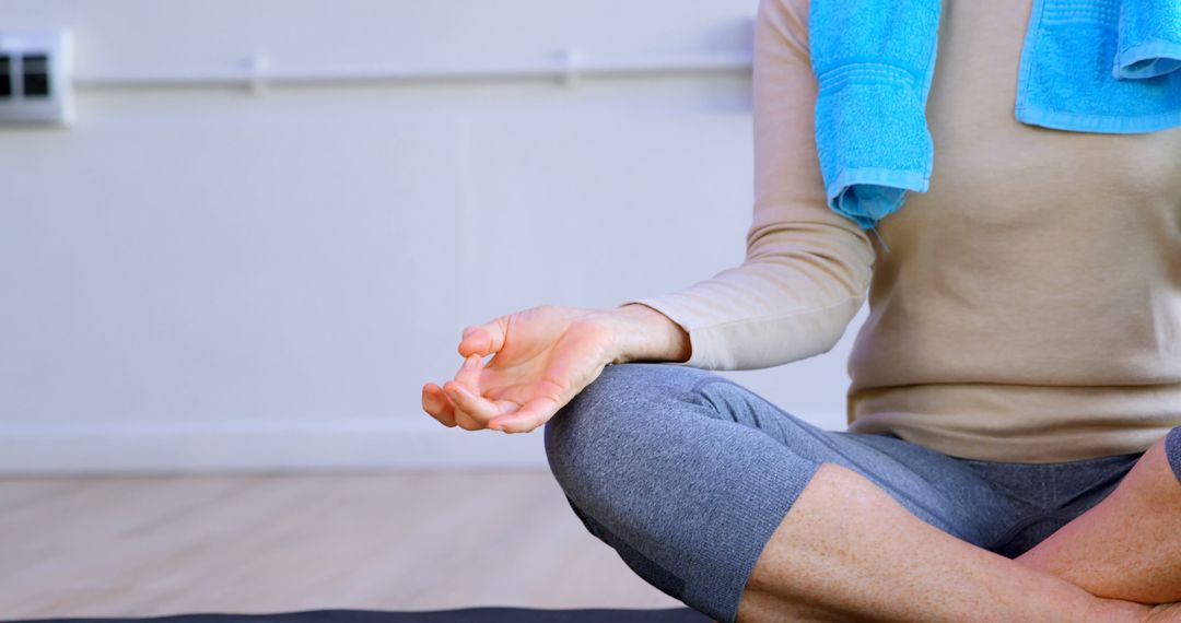 Person Practicing Yoga in Relaxing Pose with Blue Towel - Free Images, Stock Photos and Pictures on Pikwizard.com