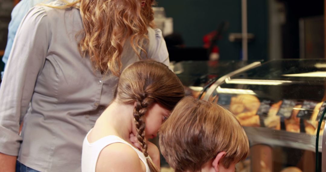 Mother with Children Choosing Pastries in Bakery - Free Images, Stock Photos and Pictures on Pikwizard.com