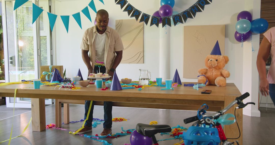 Man Preparing Birthday Party Table at Home with Decorations
