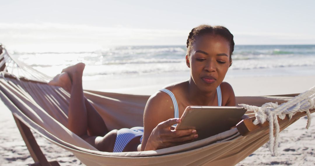 Woman Relaxing with Tablet in Beach Hammock - Free Images, Stock Photos and Pictures on Pikwizard.com