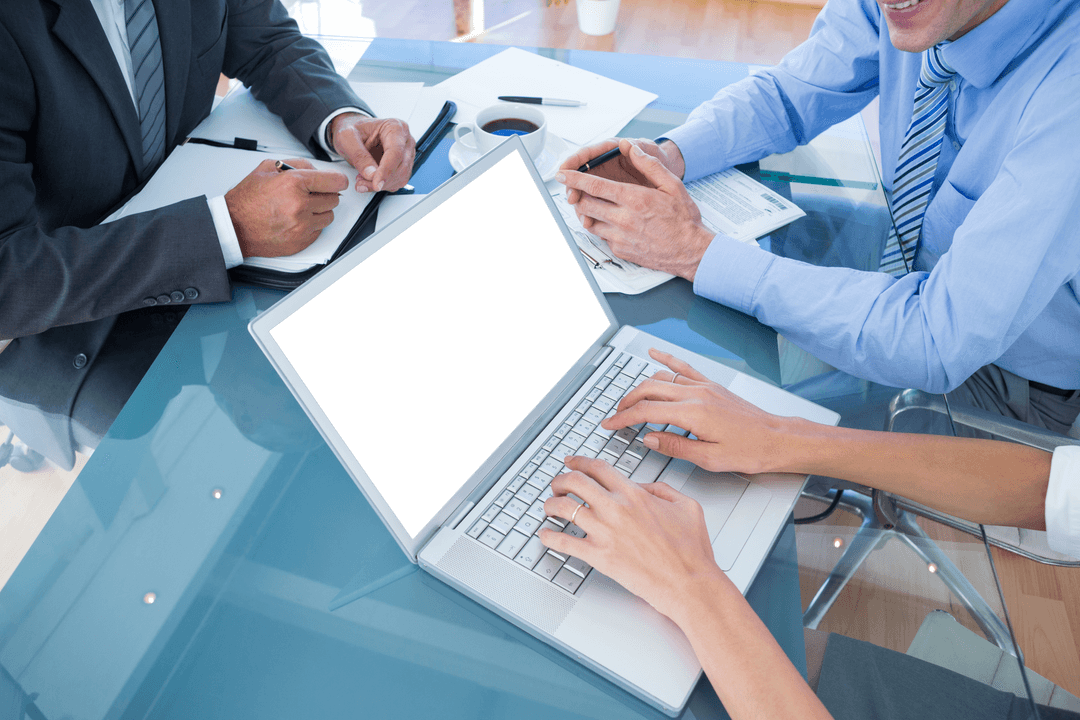 Professionals Collaborating Over Transparent Desk in Modern Office