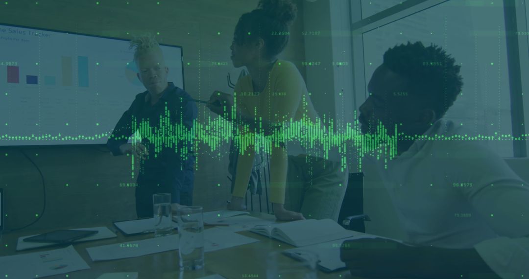 Colleagues Analyzing Digital Data in Modern Business Meeting