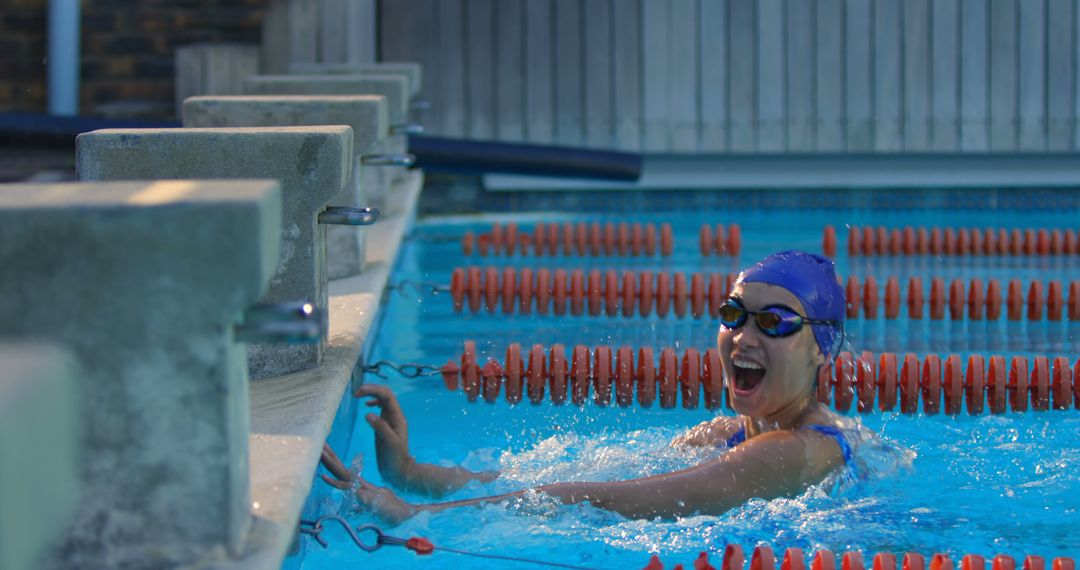 Excited Female Swimmer Celebrating in Pool After Victory - Free Images, Stock Photos and Pictures on Pikwizard.com