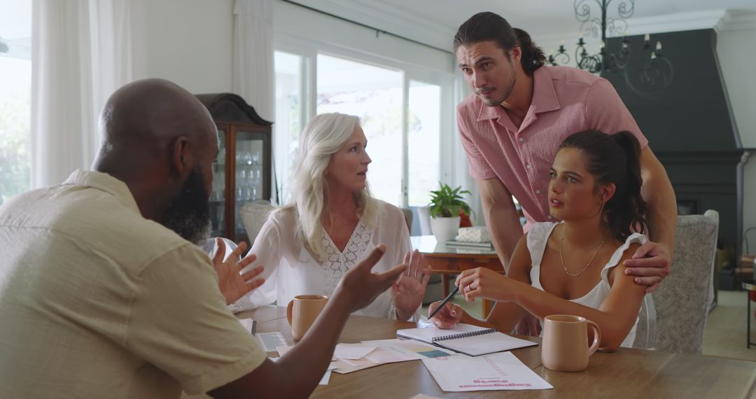 Family Collaboration on Wedding Plans Around Table with Documents