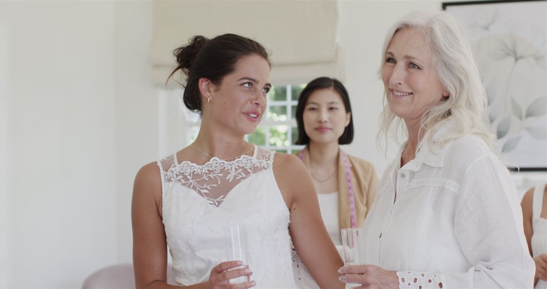 Bride Smiling with Friends in Bridal Suite During Wedding Preparation