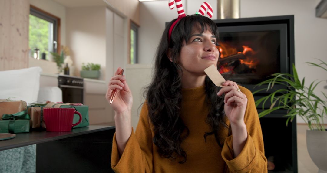 Woman Holding Gift Tag Preparing Presents in Cozy Festive Room