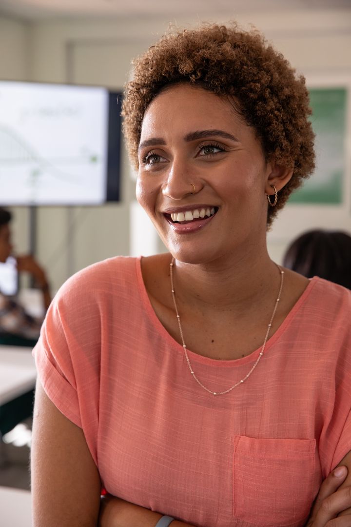 Smiling woman leading presentation with graph in modern classroom workshop
