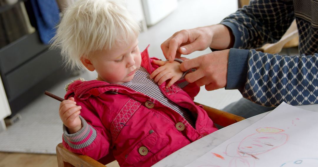 Father Helping Daughter Remove Jacket at Home