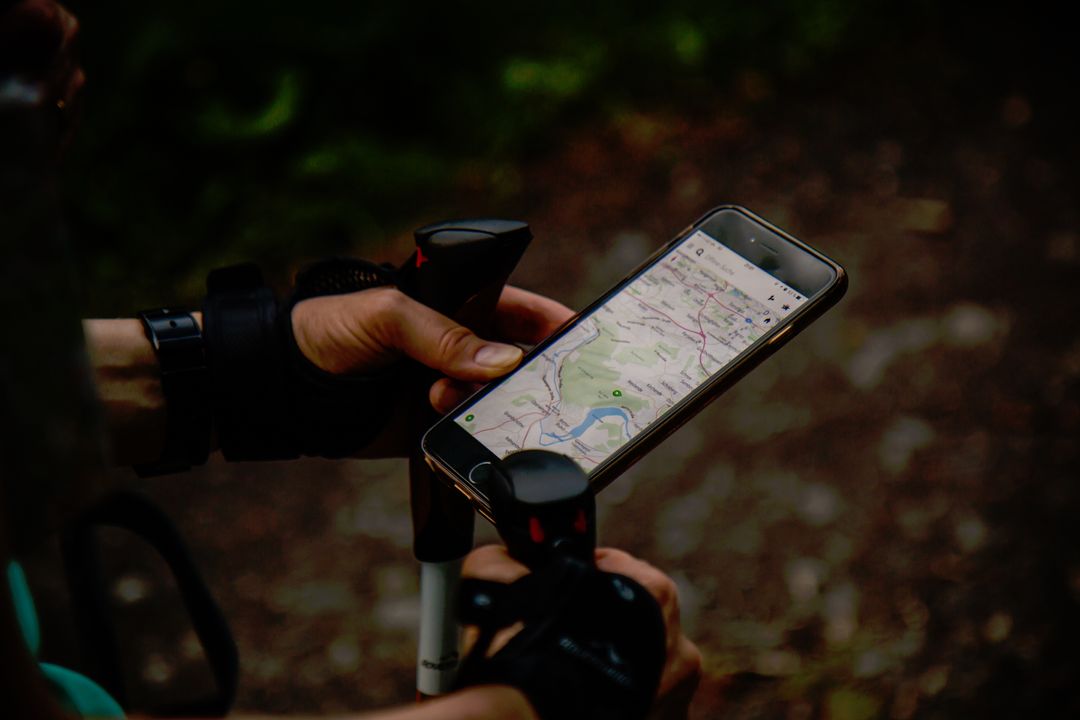 Outdoor Trail Navigation Hiker Checking Smartphone Map While Holding Trekking Poles