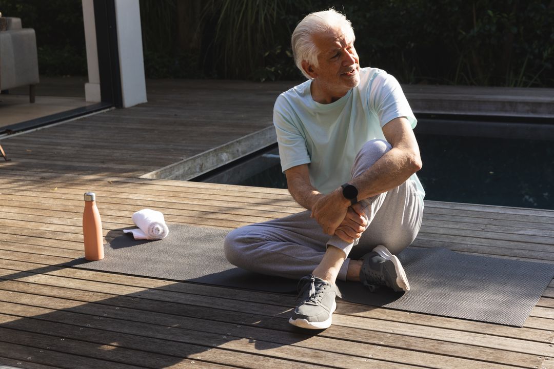 Senior Man Stretching Poolside in Relaxing Outdoor Wellness Routine