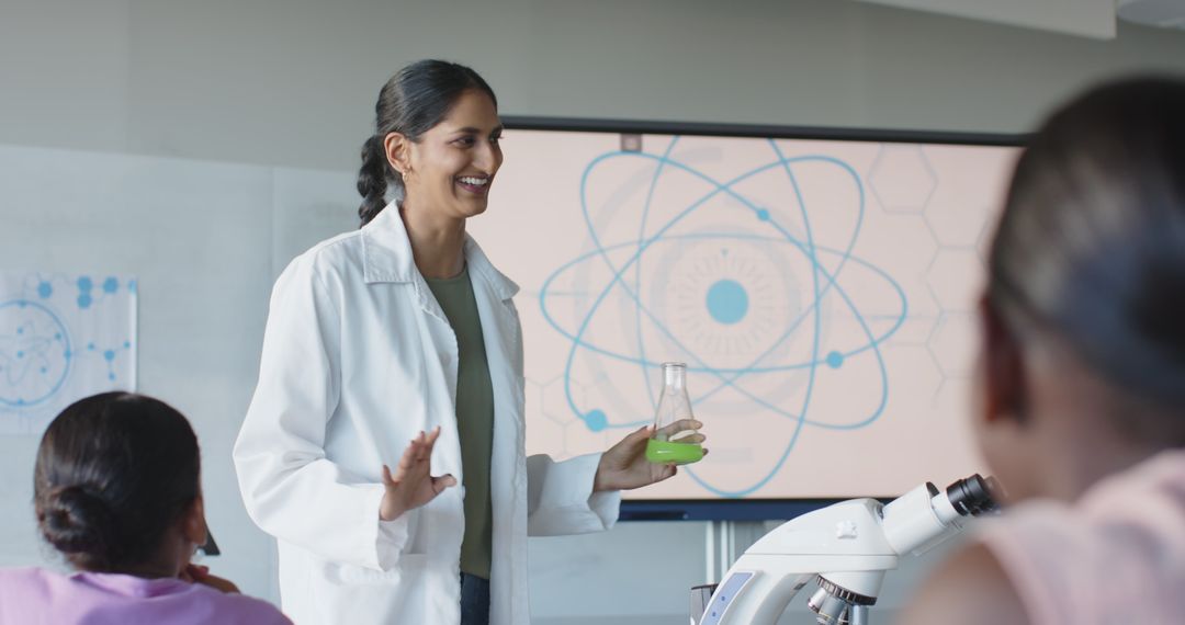 Female Teacher Demonstrating Experiment with Students in Science Lab