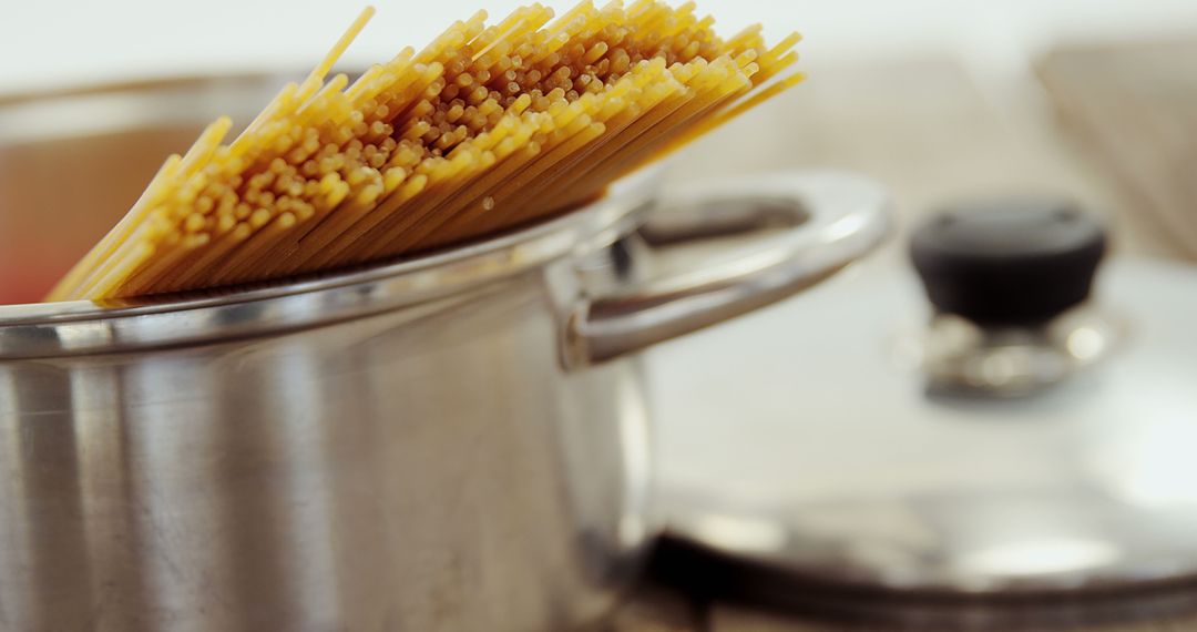 Raw Spaghetti in Stainless Steel Pot on Stove - Free Images, Stock Photos and Pictures on Pikwizard.com