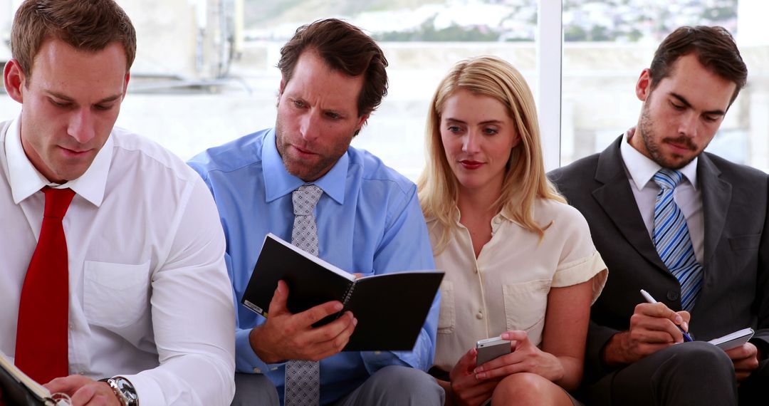 Business Team Reviewing Documents In Casual Meeting Setting - Free Images, Stock Photos and Pictures on Pikwizard.com