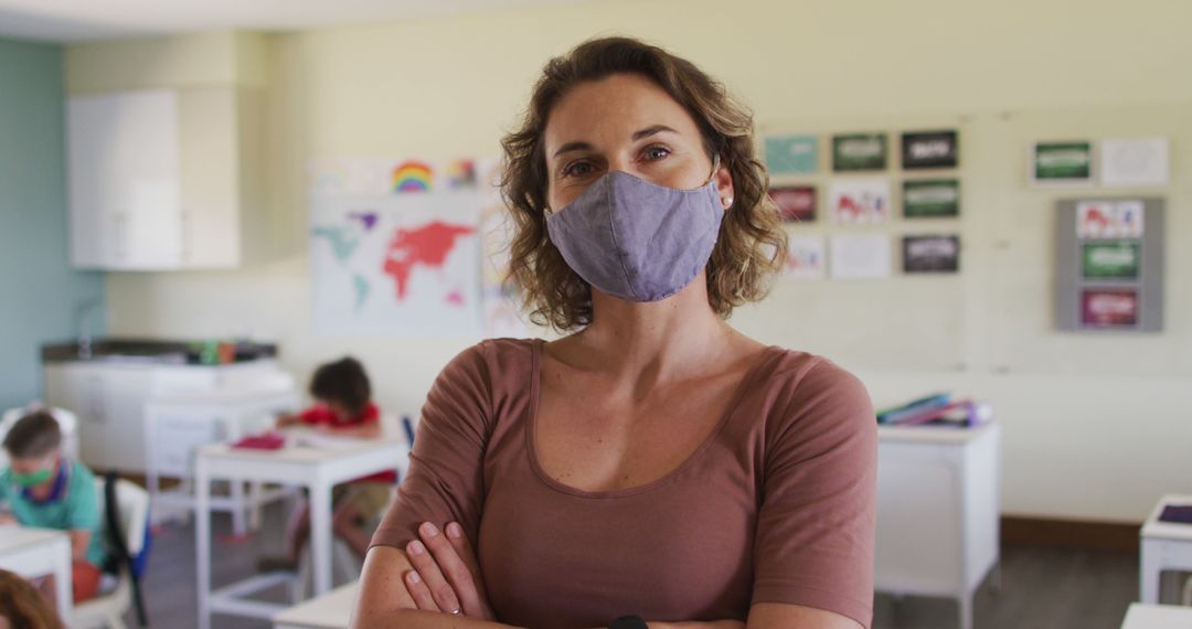 Confident teacher wearing face mask in classroom during pandemic - Free Images, Stock Photos and Pictures on Pikwizard.com