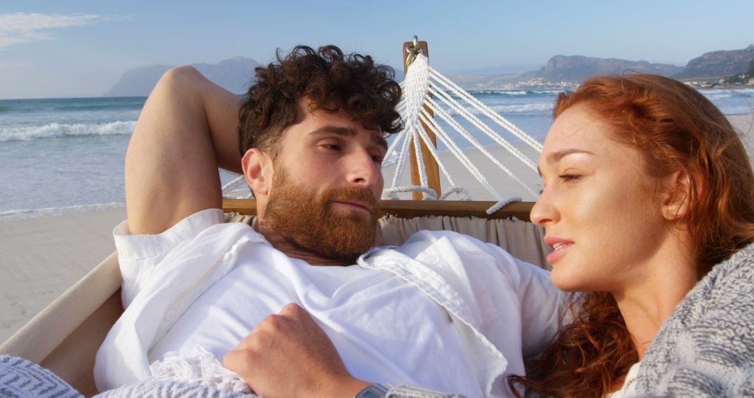 Couple Relaxing on Beach Hammock Enjoying Scenic View