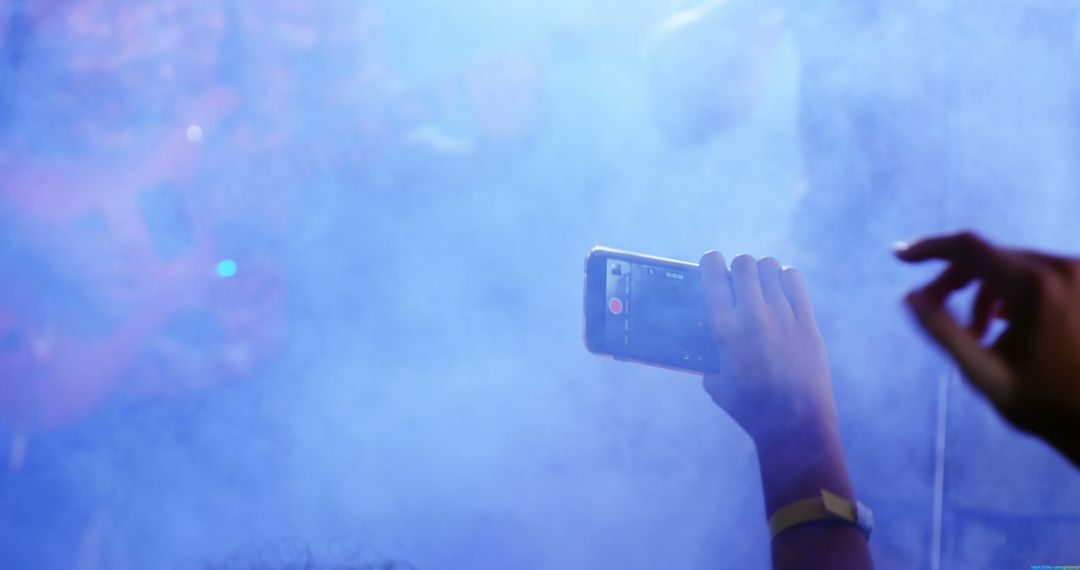 Concert Attendees Capturing Performance on Smartphone Amid Blue Fog - Free Images, Stock Photos and Pictures on Pikwizard.com