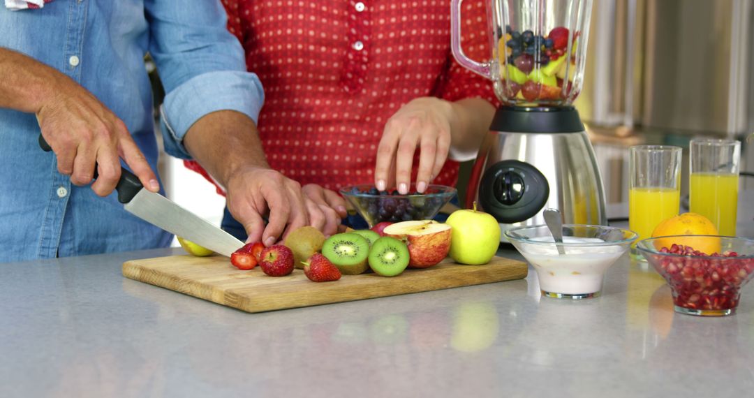 Two People Preparing Fresh Fruit Smoothie in Modern Kitchen - Free Images, Stock Photos and Pictures on Pikwizard.com