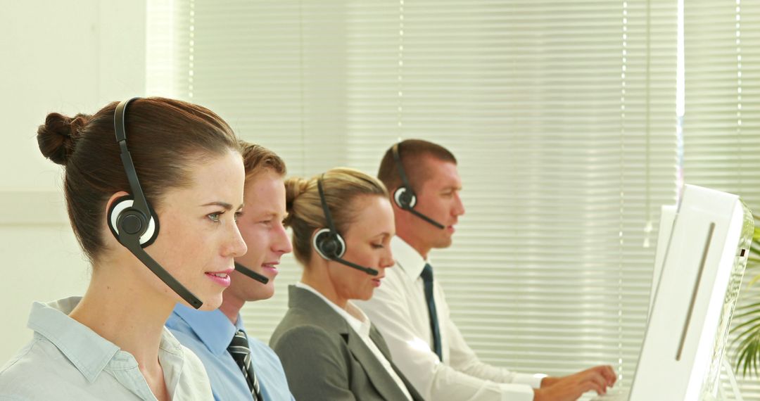 Row of Customer Service Representatives using Headsets - Free Images, Stock Photos and Pictures on Pikwizard.com