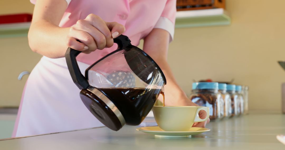 Waitress Pouring Fresh Coffee into Yellow Cup in Diner - Free Images, Stock Photos and Pictures on Pikwizard.com