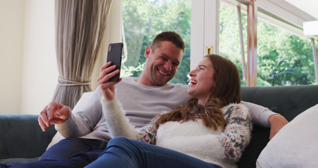 Couple Enjoying Video Call Together at Home in Relaxed Atmosphere