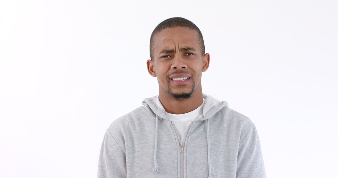 Man in Gray Hoodie Expressing Confusion in Studio