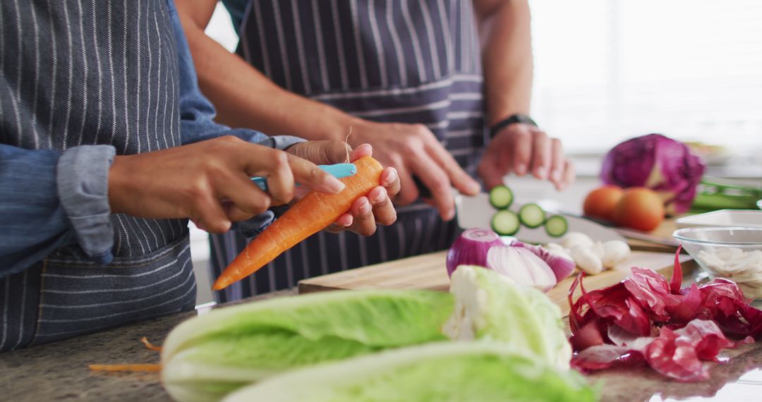 Couple preparing fresh vegetables in kitchen - Free Images, Stock Photos and Pictures on Pikwizard.com