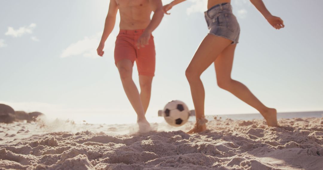 Young Couple Playing Soccer on Sunny Beach - Free Images, Stock Photos and Pictures on Pikwizard.com