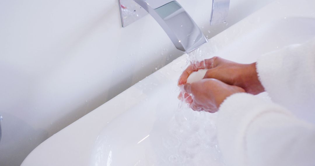 Close-Up of Hands Washing Under Running Water in Bathroom Sink - Free Images, Stock Photos and Pictures on Pikwizard.com