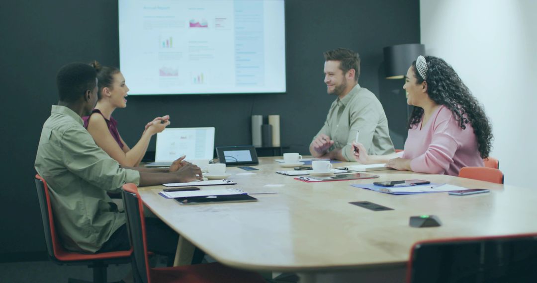 Diverse Team Brainstorming in Modern Office with Technology Display