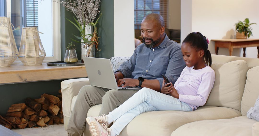 Father and Daughter Enjoying Tech Time Together at Home