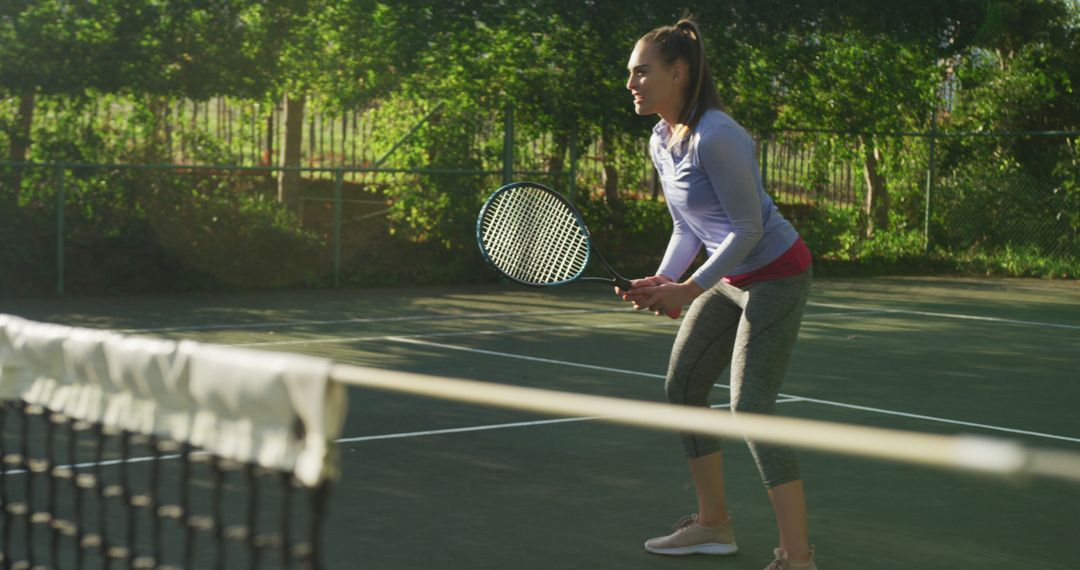 Young Woman Playing Tennis Outdoors on Sunny Day - Free Images, Stock Photos and Pictures on Pikwizard.com