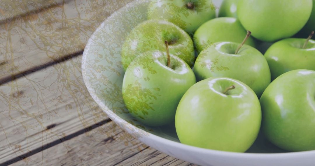 Bowl of Glossy Green Apples on Rustic Wooden Table