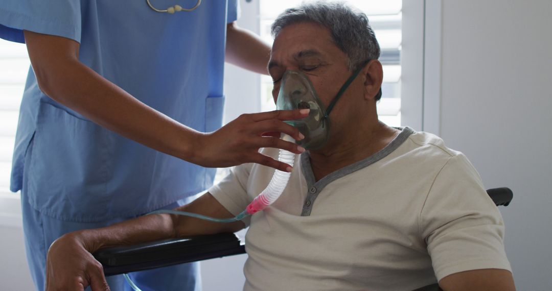 Nurse Adjusting Oxygen Mask for Elderly Patient in Wheelchair - Free Images, Stock Photos and Pictures on Pikwizard.com