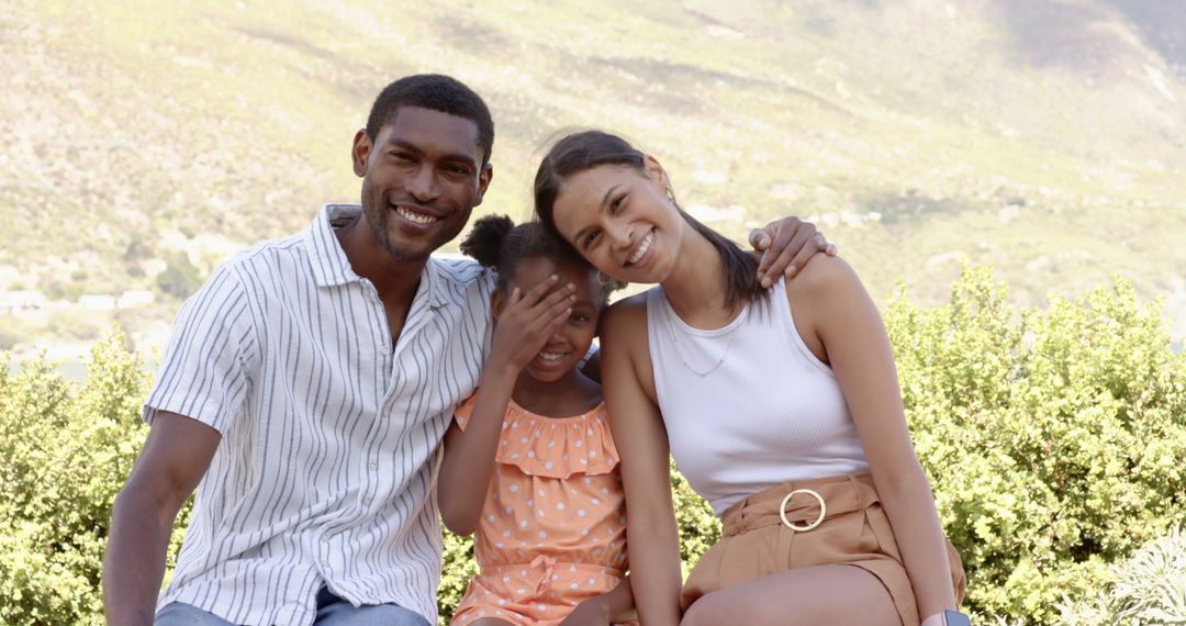 Happy Family Relaxing on Park Bench in Natural Setting