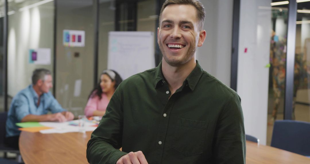 Smiling professional leading collaborative brainstorming session in modern meeting room