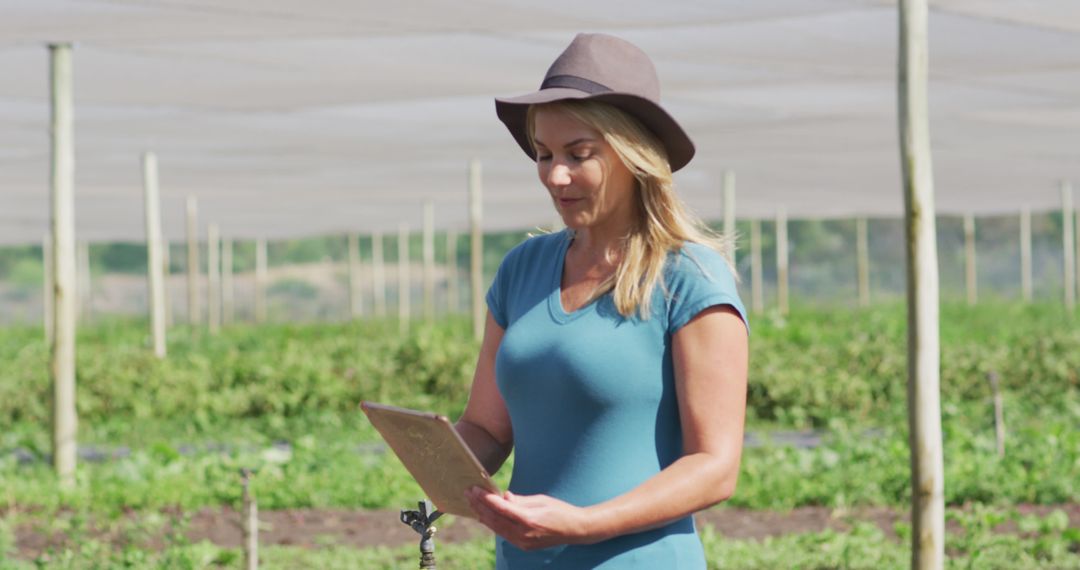 Farmer Woman Using Digital Tablet in Field - Free Images, Stock Photos and Pictures on Pikwizard.com