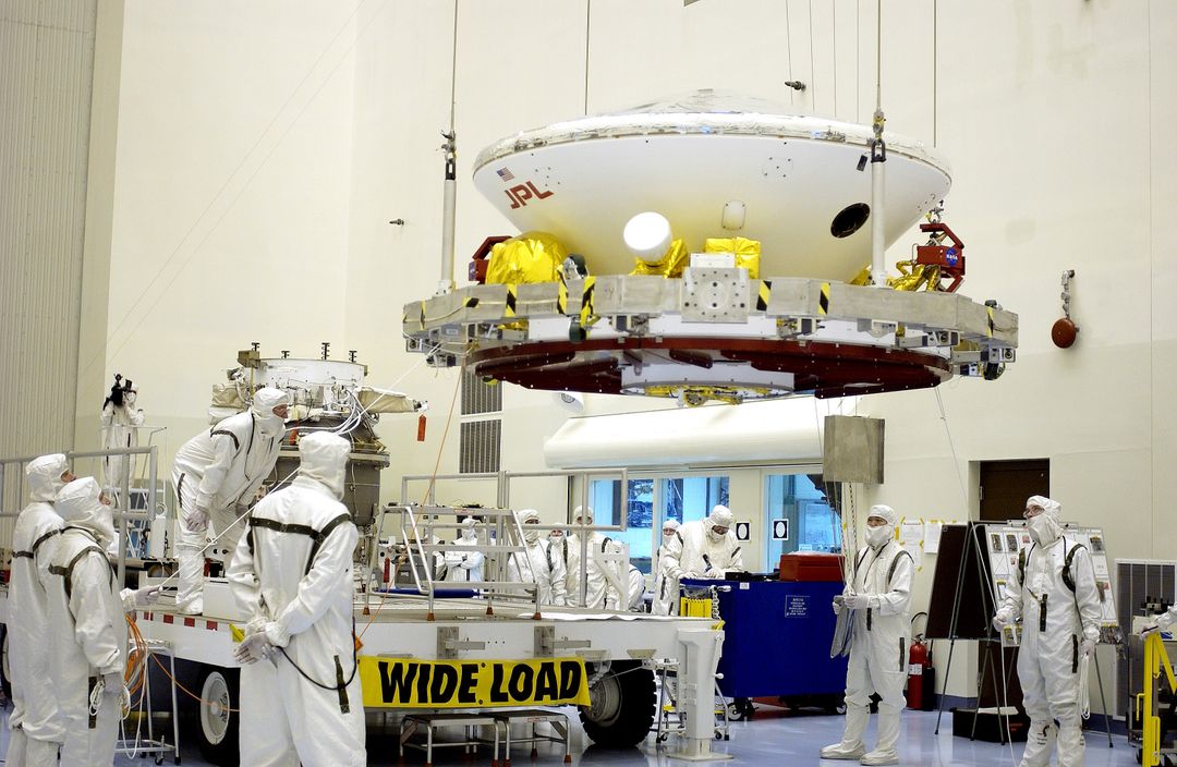 KENNEDY SPACE CENTER, FLA. -  In the Payload Hazardous Servicing Facility, workers prepare to mate the Mars Exploration Rover-2 (MER-2) to the third stage of a Delta II rocket for launch on June 5.  NASA’s twin Mars Exploration Rovers are designed to stud - Free Images, Stock Photos and Pictures on Pikwizard.com