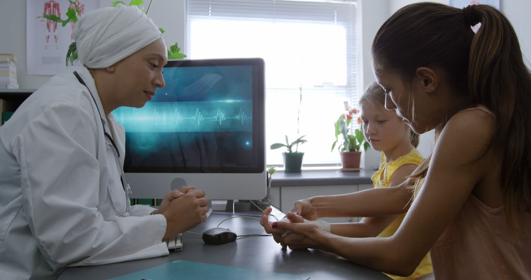 Doctor Discussing Health with Mother and Daughter in Medical Office - Free Images, Stock Photos and Pictures on Pikwizard.com