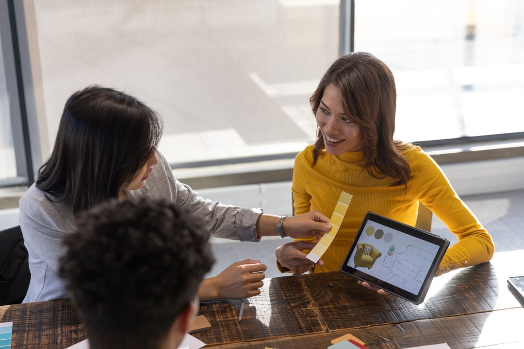 Creative Team Collaborating with Tablet and Color Swatches in Office