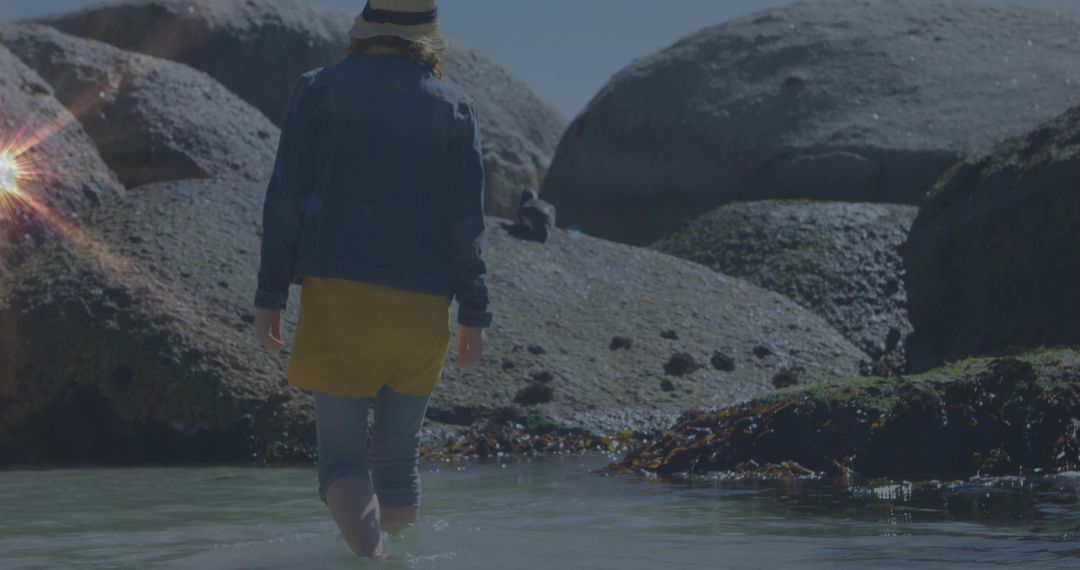 Woman Exploring Coastal Tidal Pool in Serene Outdoor Setting