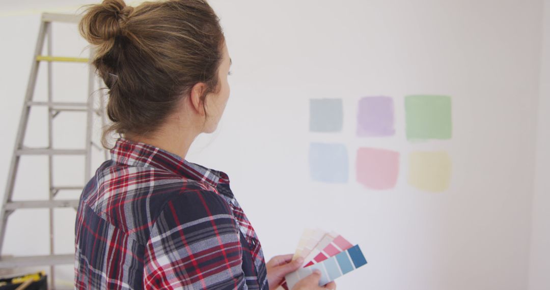 Woman Choosing Wall Colors with Swatches Inside Home - Free Images, Stock Photos and Pictures on Pikwizard.com