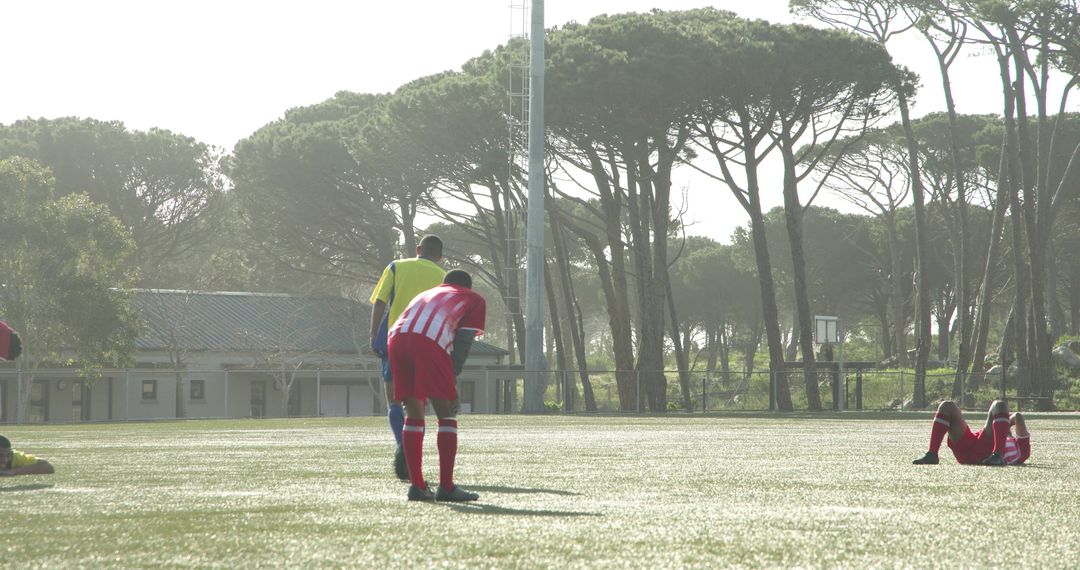 Soccer Players Demonstrating Teamwork on Sunny Field
