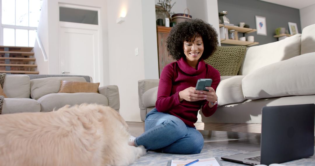 Happy Woman Using Smartphone at Home with Pet and Laptop on Floor - Free Images, Stock Photos and Pictures on Pikwizard.com