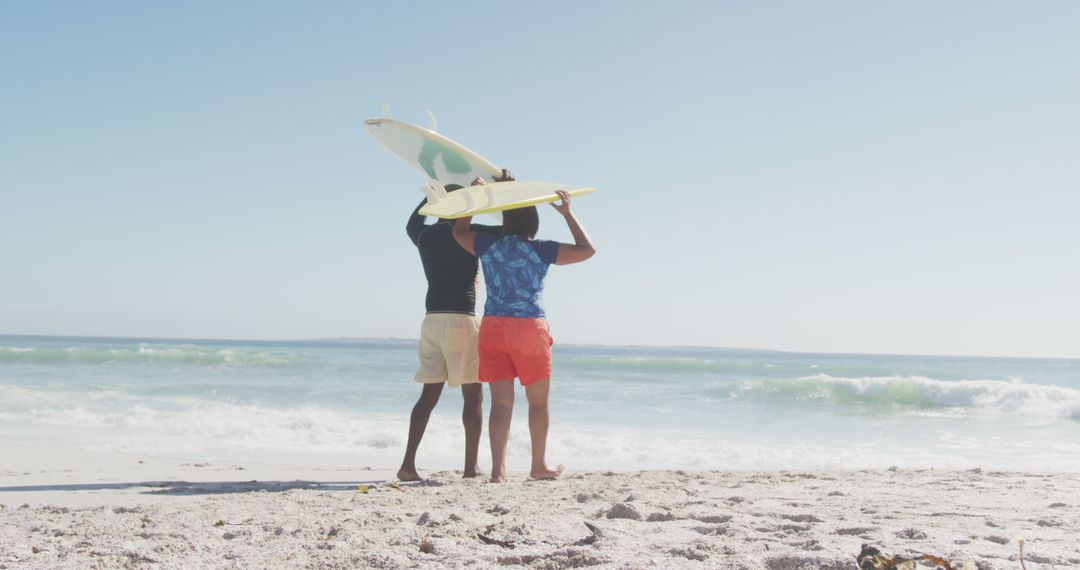 Two Friends Holding Surfboards at Sandy Beach on Sunny Day - Free Images, Stock Photos and Pictures on Pikwizard.com