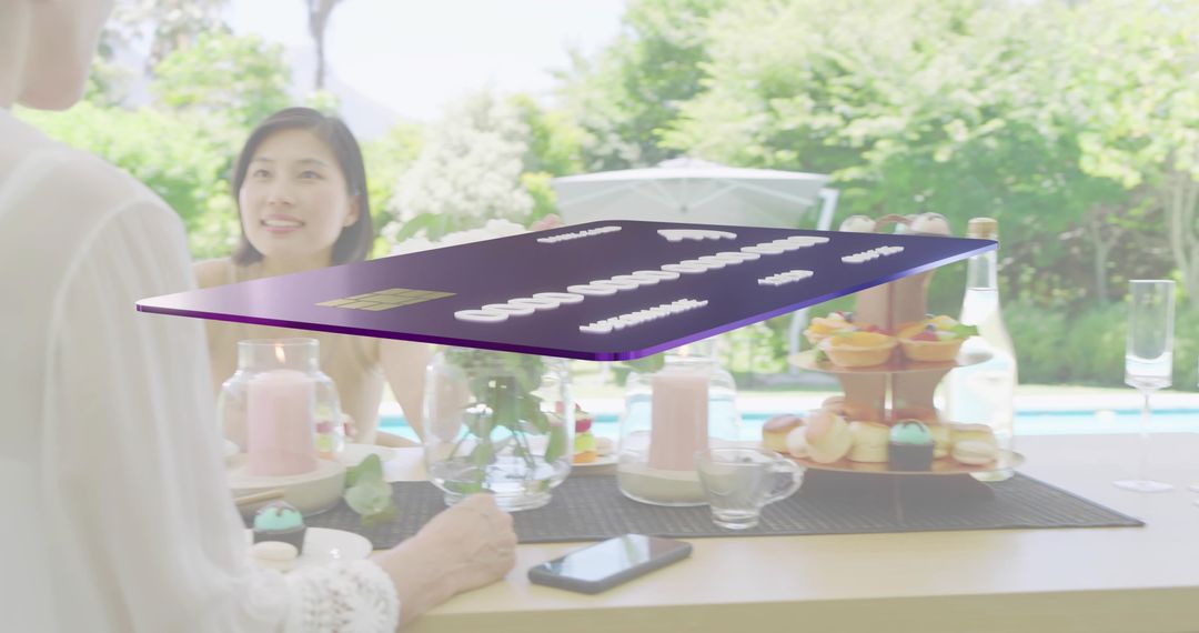 Floating purple credit card hovering over poolside dessert table, multigenerational gathering
