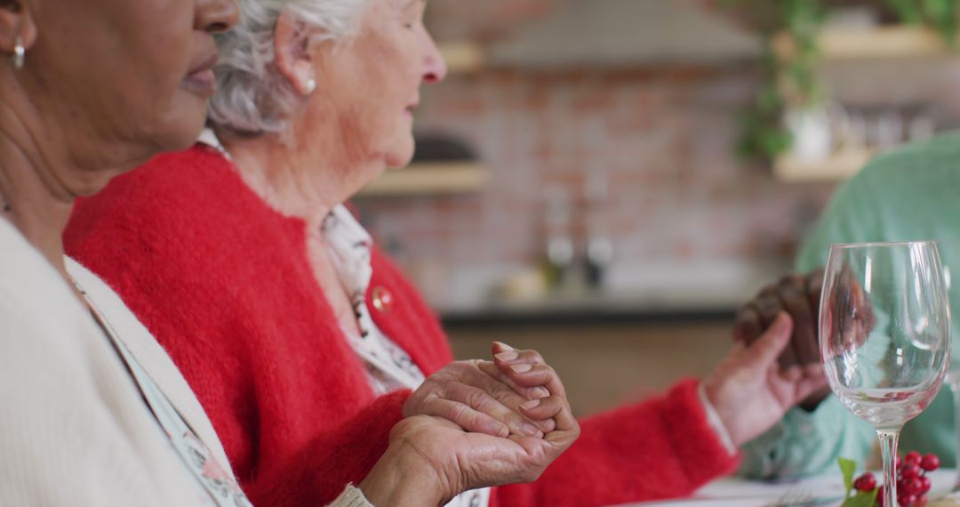 Senior Women Holding Hands at Dining Table During Prayer - Free Images, Stock Photos and Pictures on Pikwizard.com