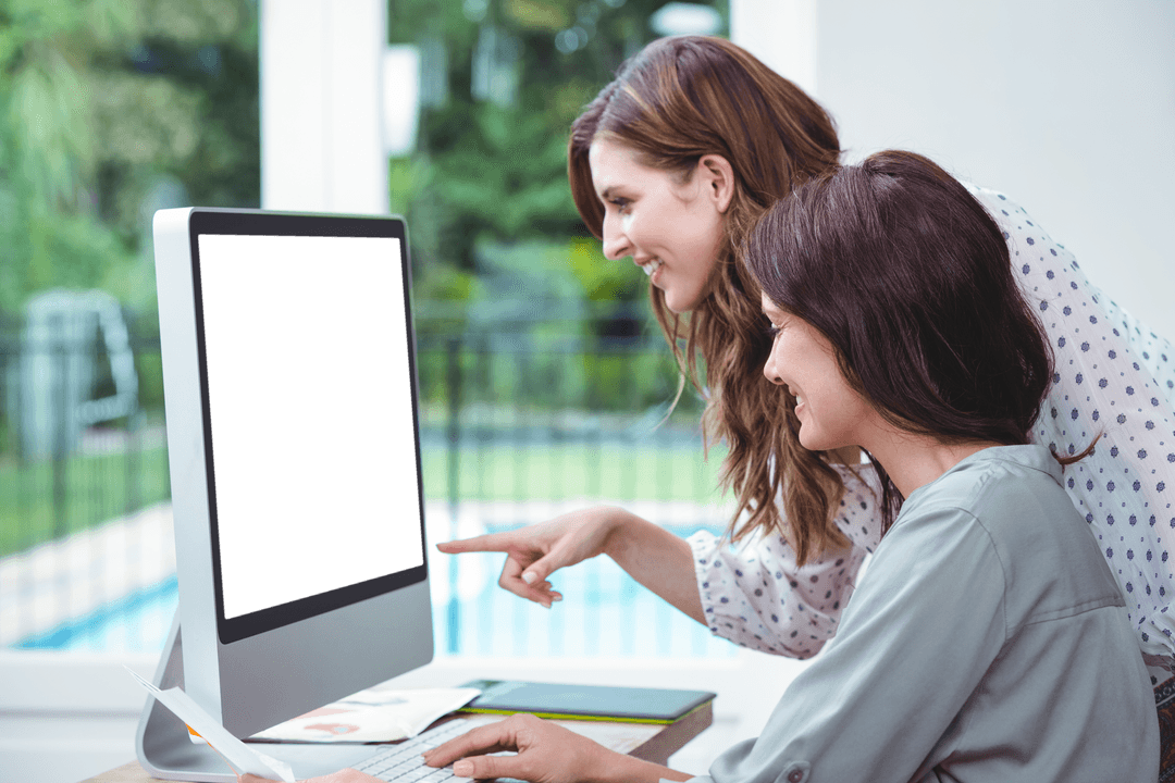 Two Women Engaged with Computer Discussing Innovative Ideas at Home with Transparent Background